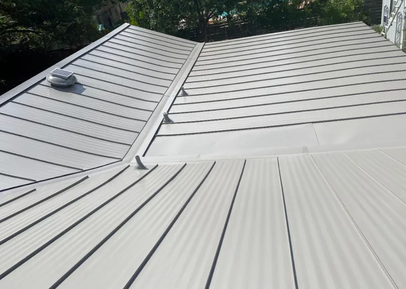 Solar attic fan installed on a metal roof for Roof Ventilation in Syracuse
